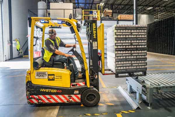 forklift moving pallets of canned goods