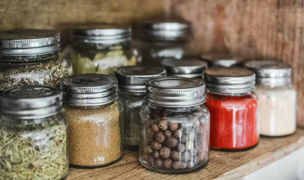 small glass jars of herbs and spices